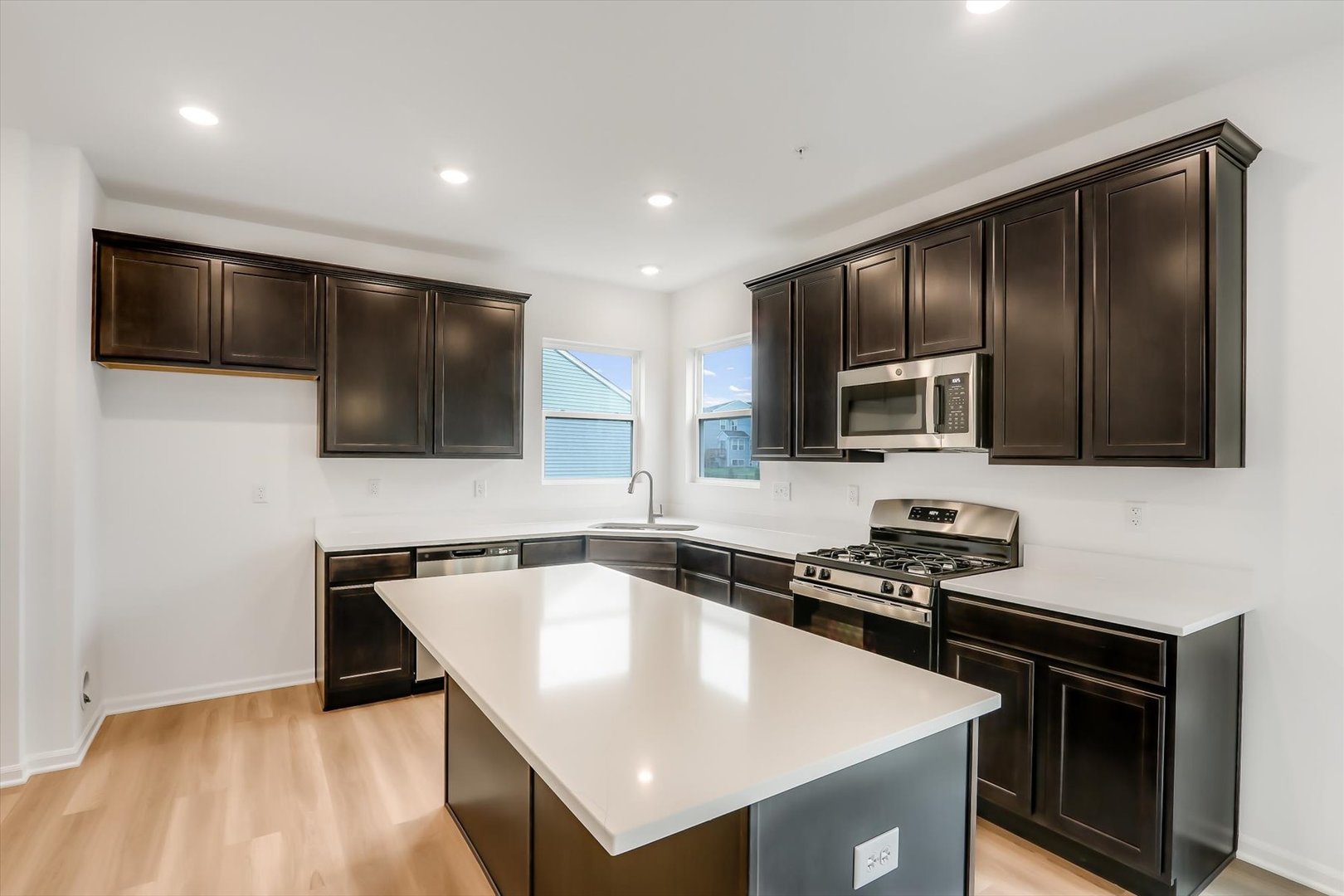 468 Endicott Road South Elgin, IL 60177 - Photo 10 of 32 a kitchen with stainless steel appliances granite countertop a sink a stove a microwave and cabinets