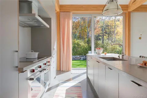 a kitchen with stainless steel appliances a sink and a large window