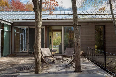 a view of a chairs and a table in the patio