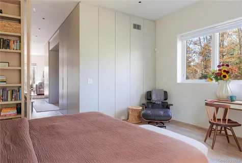 a bedroom with a bed and chair