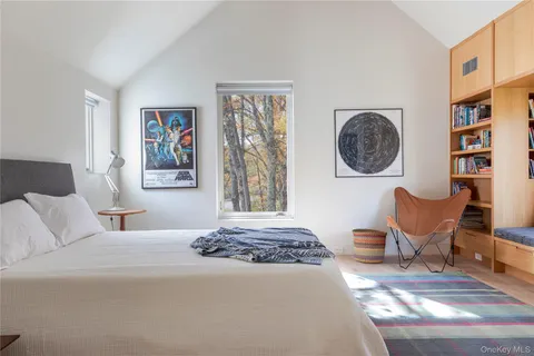 a bedroom with a bed and painting on the wall