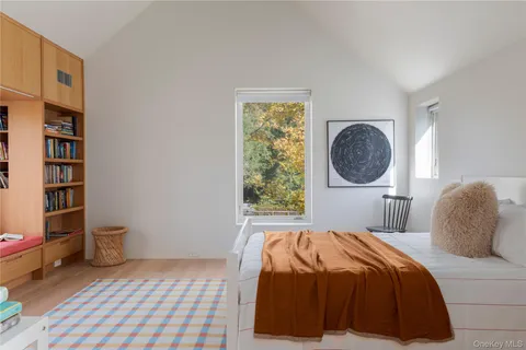 a bedroom with a bed a closet and a bookshelf