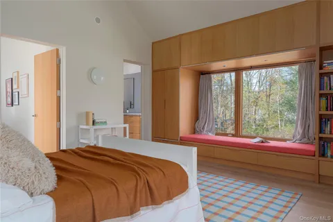 a bedroom with a bed and a large window
