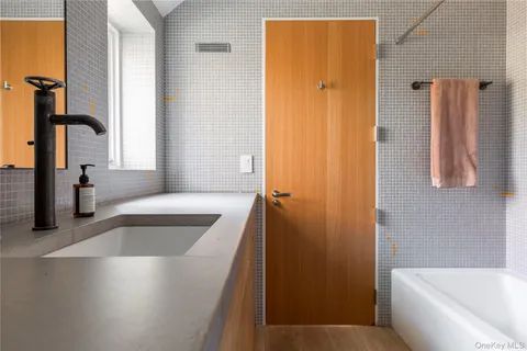 a bathroom with a tub a sink and a shower curtain