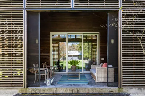 a view of house with swimming pool and sitting area