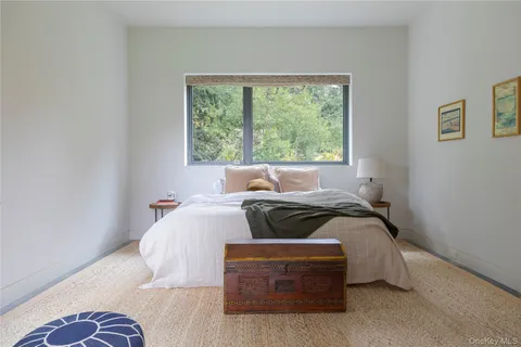 a bedroom with a bed and glass window