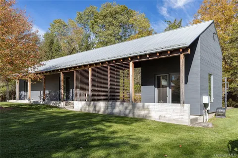 a front view of a house with a garden and yard