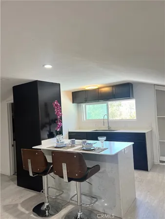 a living room with granite countertop furniture a rug and a window