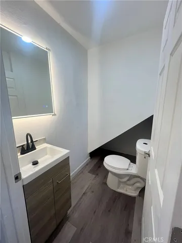 a bathroom with a sink a toilet and mirror