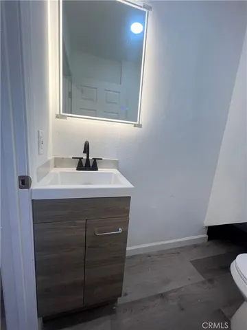 a bathroom with a sink a vanity and a toilet