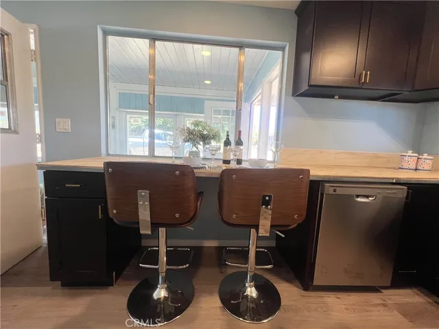 a room with a sink a mirror and cabinets