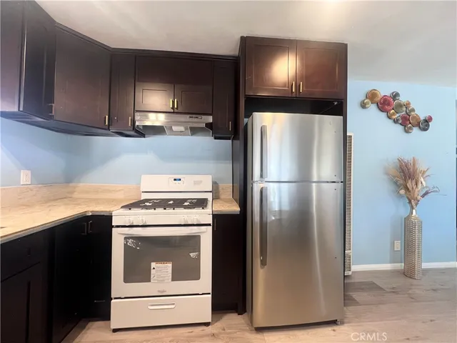 a kitchen with a refrigerator and a stove