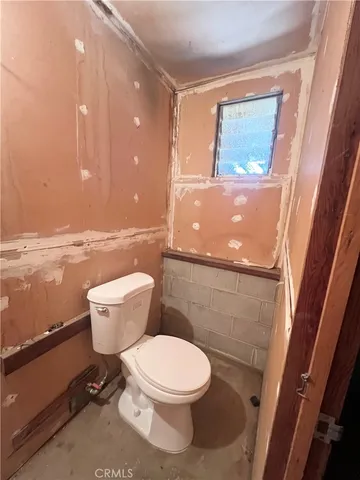 a white toilet sitting next to a bathroom sink
