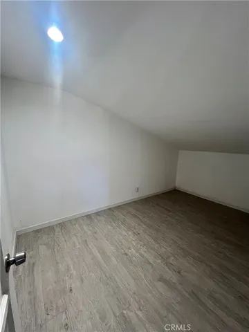 a view of an empty room and wooden floor