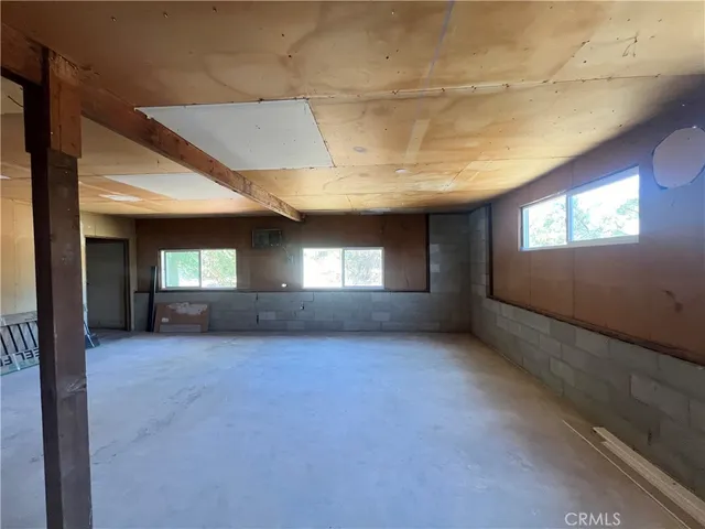 a view of an empty room with window and fireplace