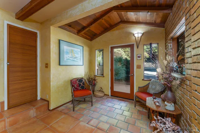 a living room with furniture a flat screen tv and a table