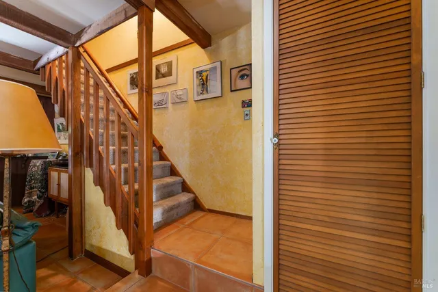 a bedroom with a bed a table and chair