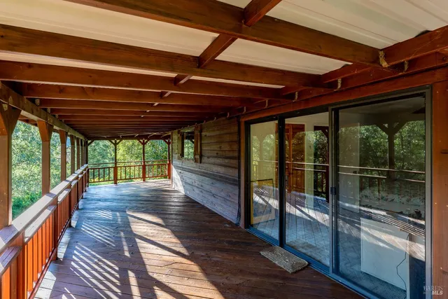 a view of a patio with a table chairs and a backyard