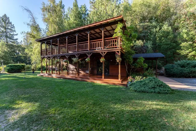 a living room with furniture and a dining table with wooden floor