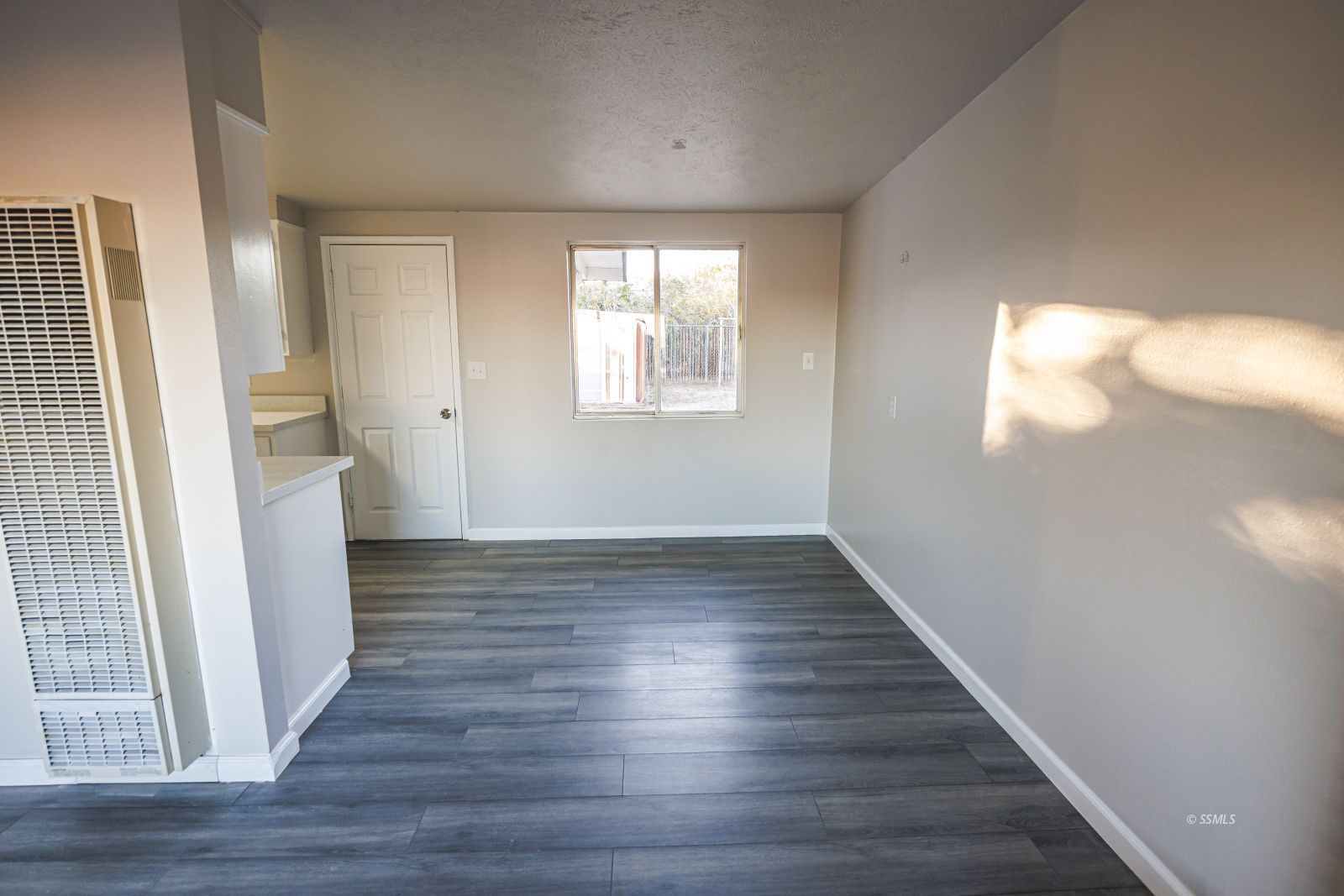 1525 South Porter Ridgecrest, CA 93555 - Photo 7 of 29 a view of an empty room with wooden floor and a window