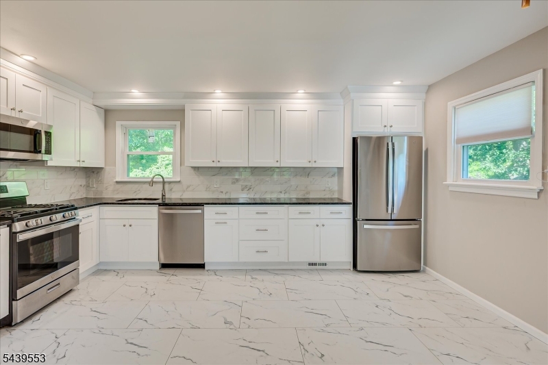 15 Woodmere Street Raritan, NJ 08869 - Photo 7 of 16 a kitchen with a refrigerator and a stove top oven