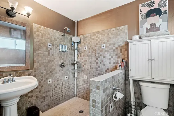 a bathroom with a sink toilet and shower