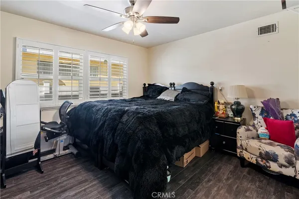 a bed room with a bed and a chair