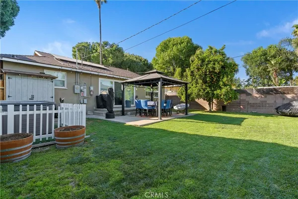 a front view of a house with a yard table and chairs
