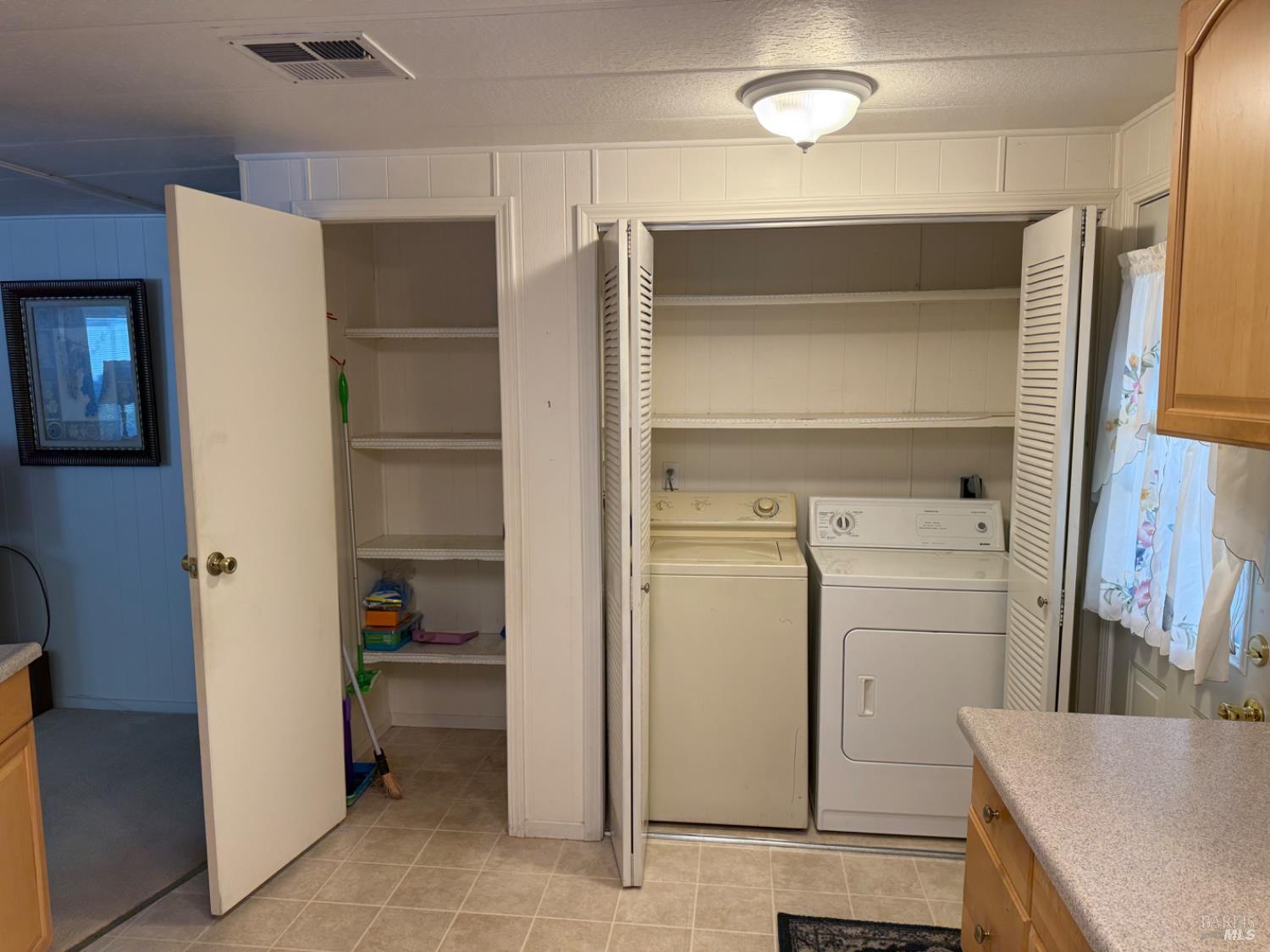 82 Charro Drive Santa Rosa, CA 95401 - Photo 8 of 22 Full size laundry appliances and great pantry storage.