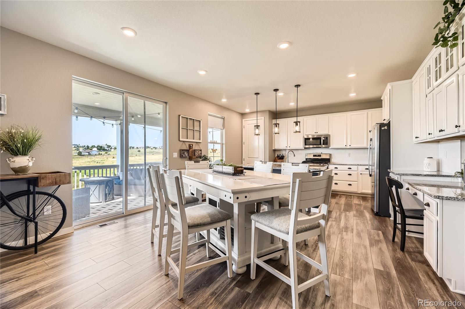 1182 Williams Loop Elizabeth, CO 80107 - Photo 14 of 42 a view of a dining room with furniture window and wooden floor