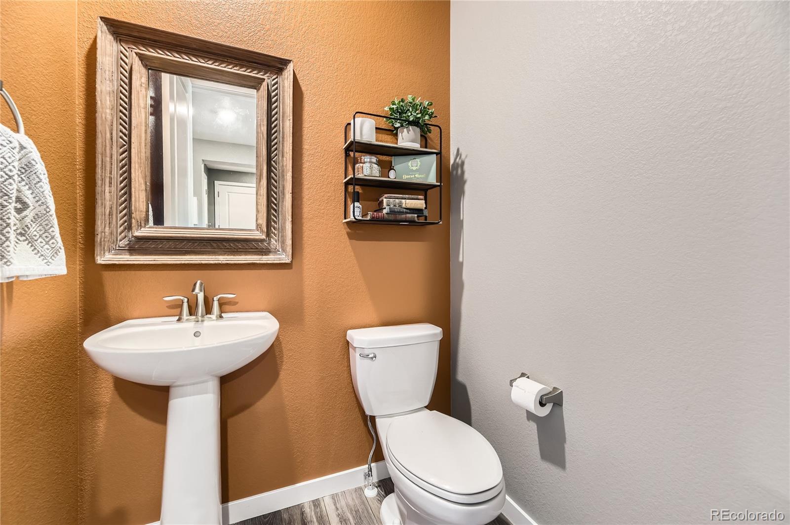 1182 Williams Loop Elizabeth, CO 80107 - Photo 15 of 42 a bathroom with a sink mirror and toilet