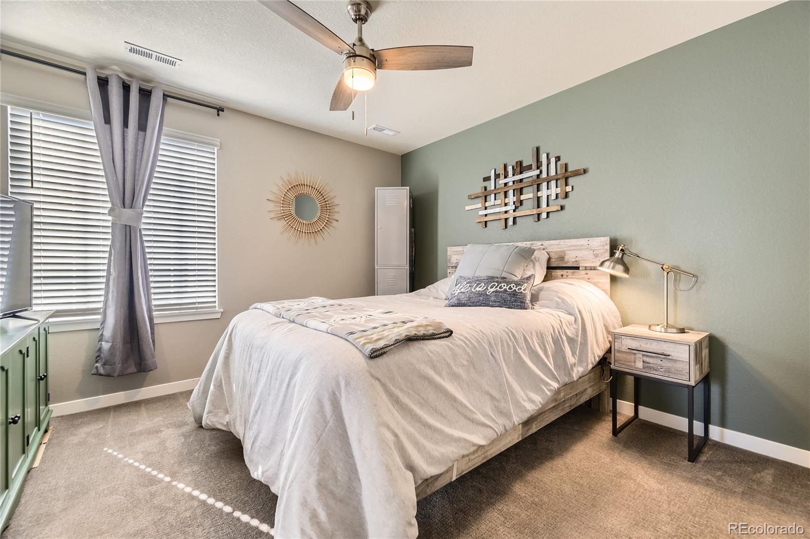 1182 Williams Loop Elizabeth, CO 80107 - Photo 19 of 42 a bedroom with a bed and a table