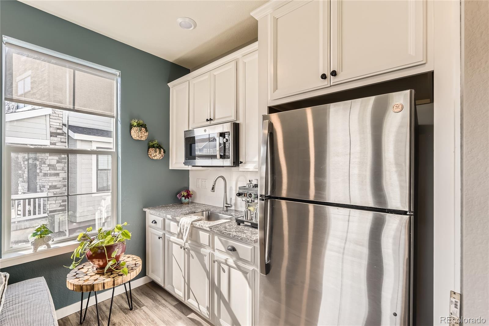 1182 Williams Loop Elizabeth, CO 80107 - Photo 27 of 42 a kitchen with stainless steel appliances granite countertop a refrigerator sink and white cabinets