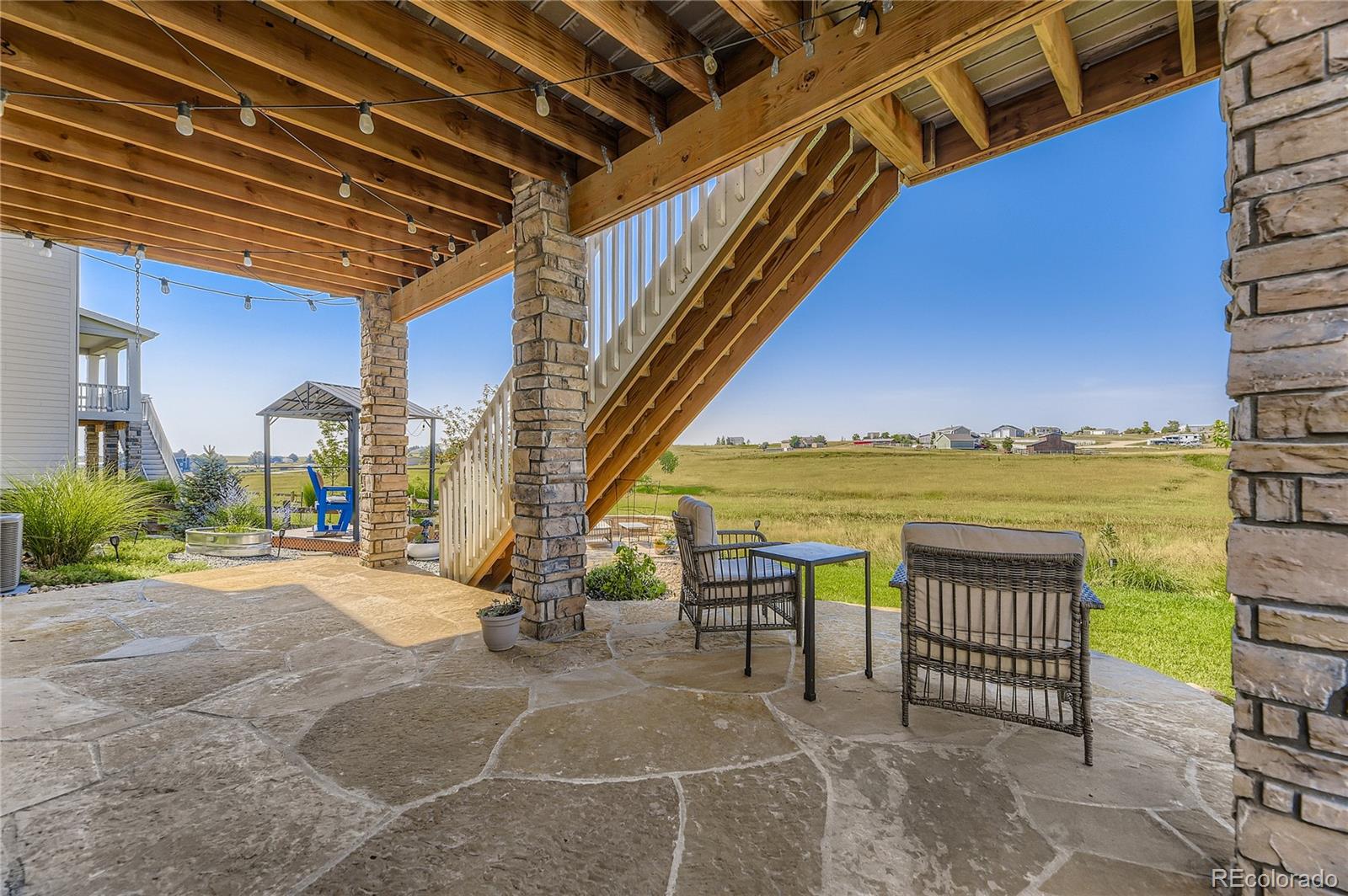 1182 Williams Loop Elizabeth, CO 80107 - Photo 35 of 42 a view of a porch with furniture and a yard
