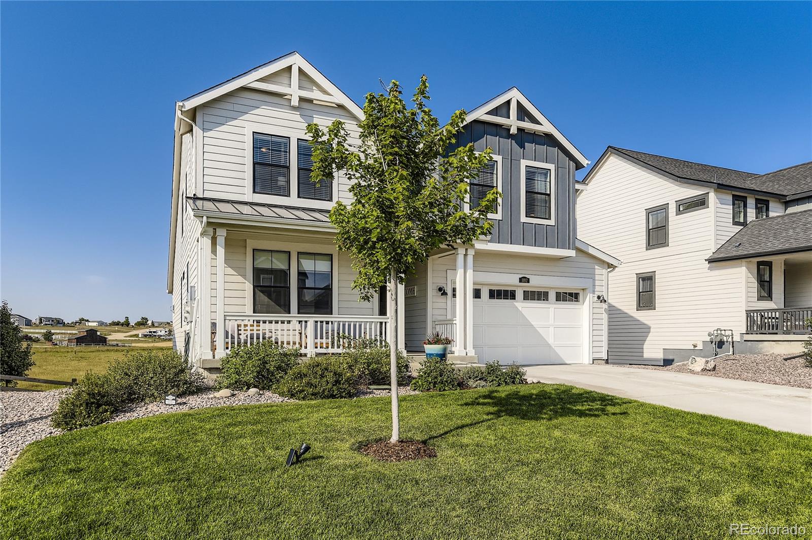 1182 Williams Loop Elizabeth, CO 80107 - Photo 6 of 42 a front view of a house with a yard and garage