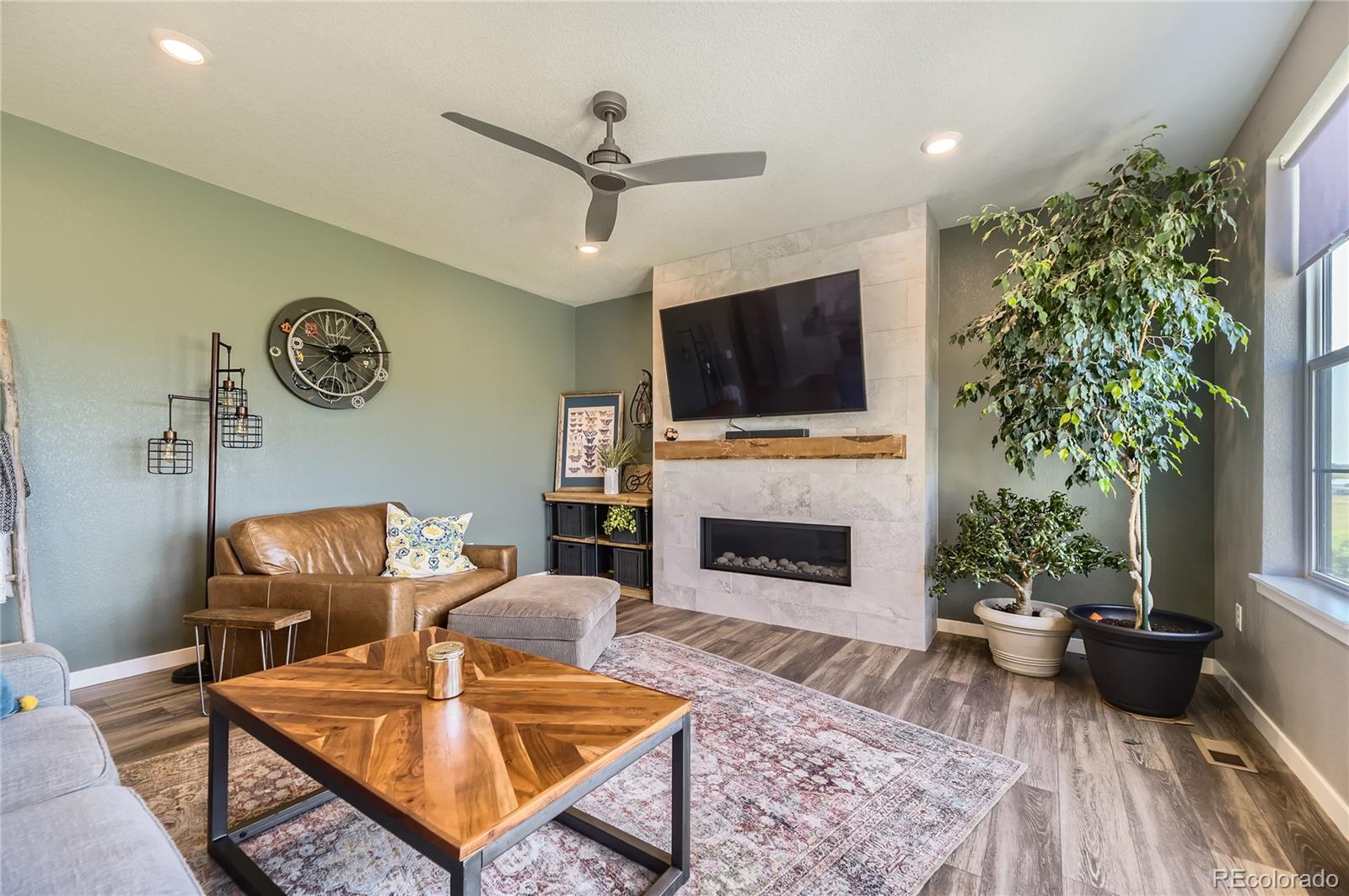 1182 Williams Loop Elizabeth, CO 80107 - Photo 10 of 42 a living room with furniture a fireplace and a flat screen tv