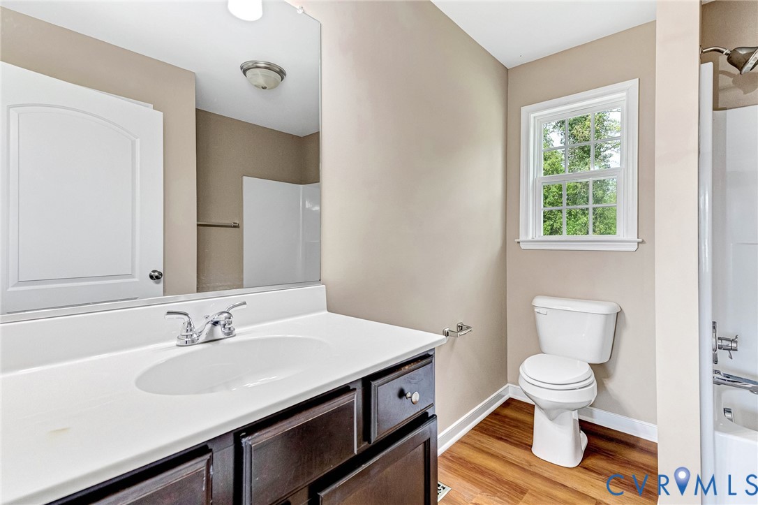 9925 Reymet Court Richmond, VA 23237 - Photo 17 of 30 a bathroom with a sink a toilet and a window