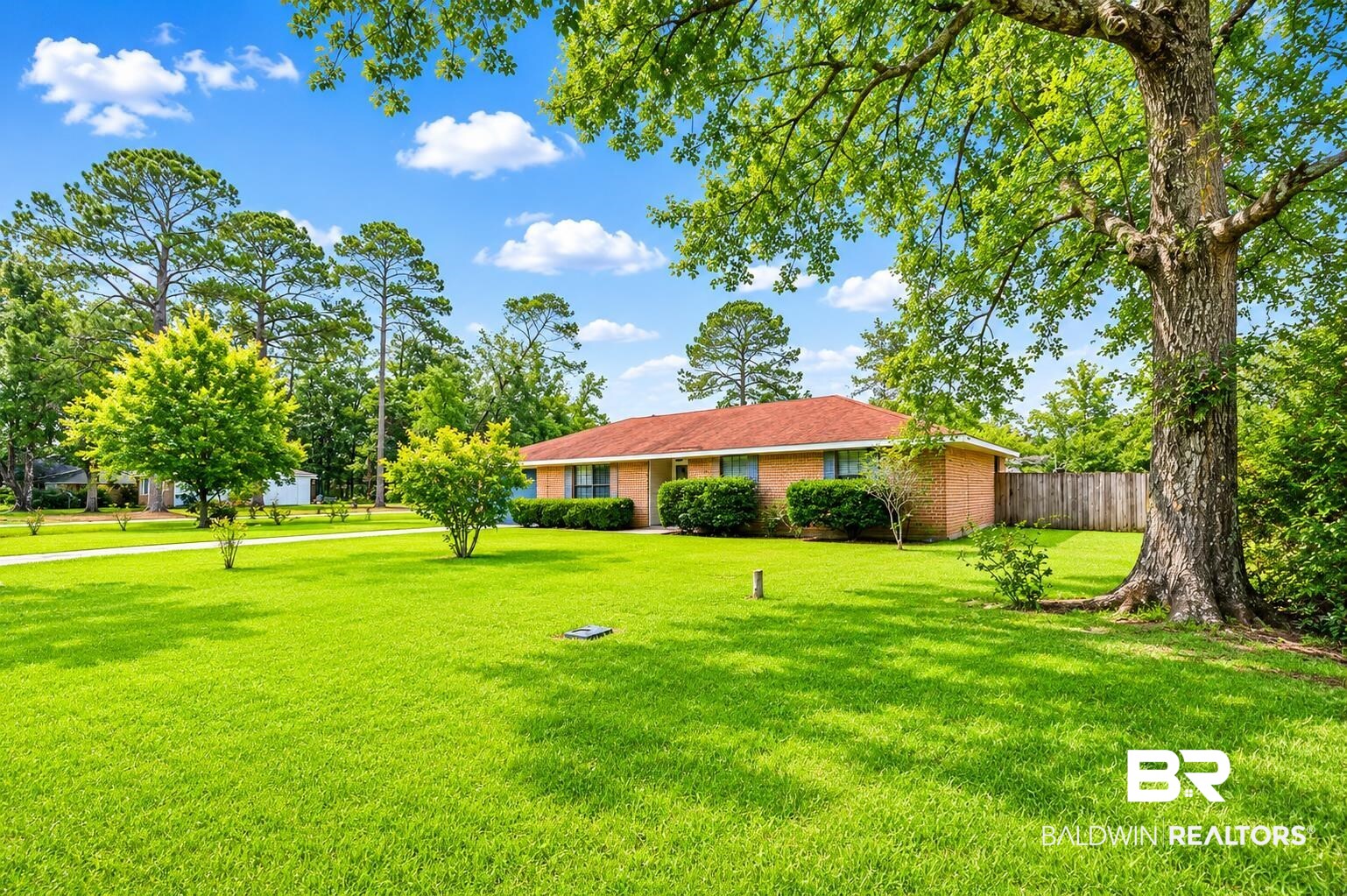 614 East Gate Circle Foley, AL 36535 - Photo 4 of 31 Spacious front yard featuring a verdant lawn, mature trees, and established shrubbery