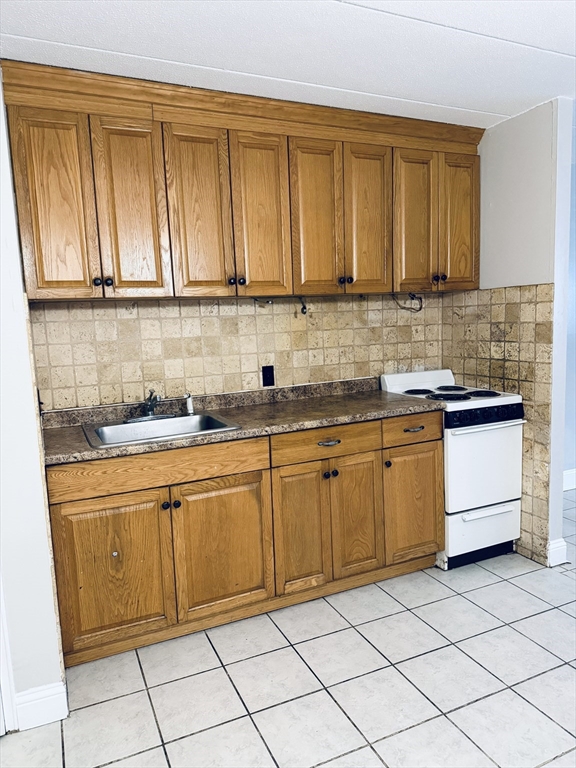 126 Beaver Street, Unit 5 Framingham, MA 01702 - Photo 2 of 11 a kitchen with stainless steel appliances granite countertop a sink and cabinets