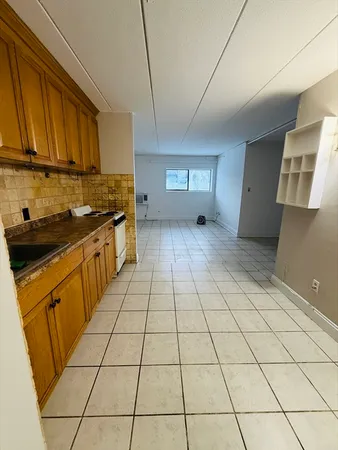 a kitchen with stainless steel appliances a sink a stove a microwave and cabinets