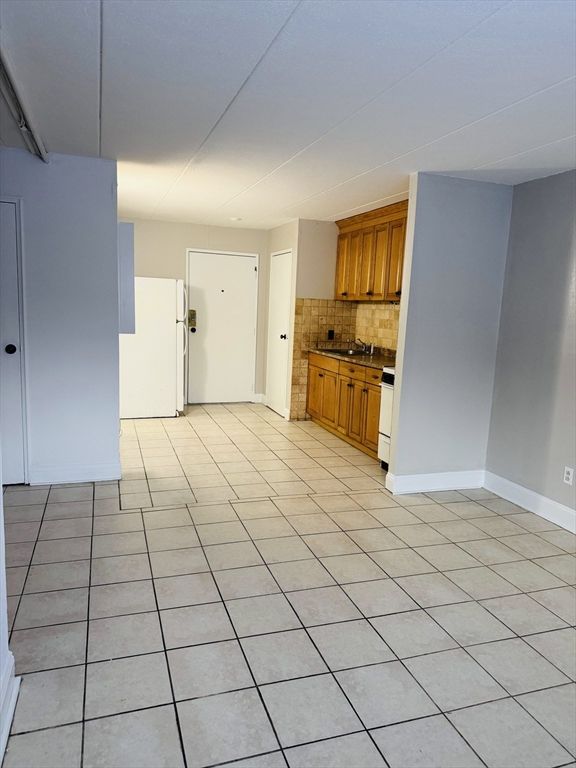 126 Beaver Street, Unit 5 Framingham, MA 01702 - Photo 5 of 11 a view of a kitchen with a sink and a stove top oven