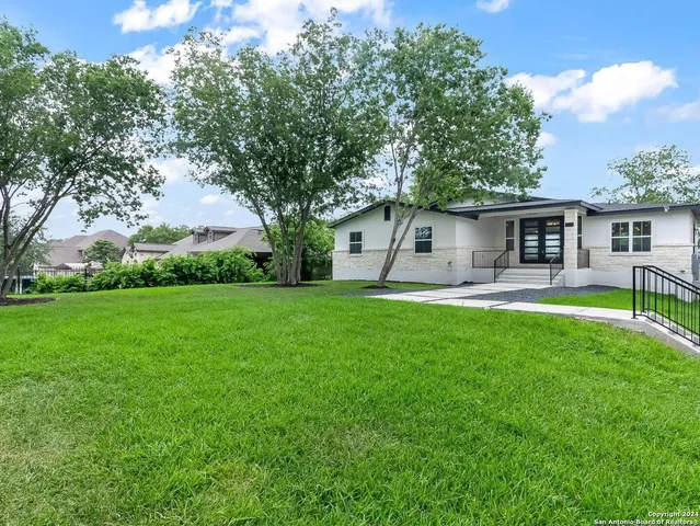 a front view of house with yard and green space