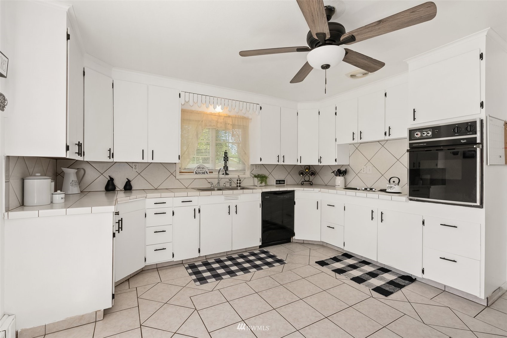 572 Rhoades Road Winlock, WA 98596 - Photo 10 of 35 a kitchen with white cabinets and appliances
