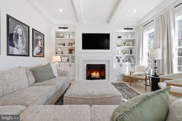 a living room with furniture fireplace and flat screen tv