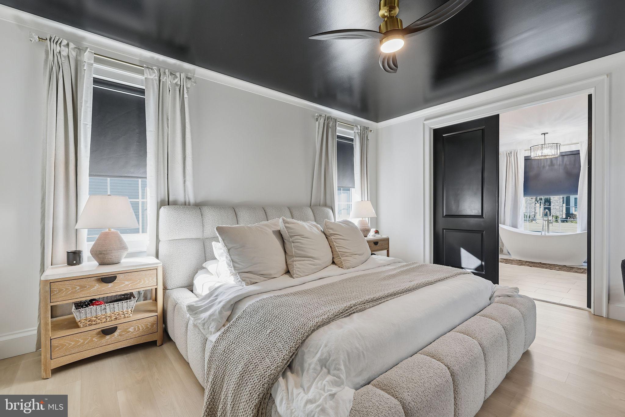 306 Shore Lane Milford, DE 19963 - Photo 17 of 38 a bedroom with a large bed and a chandelier