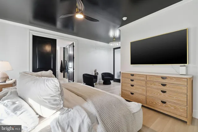 a bedroom with a bed and a flat screen tv