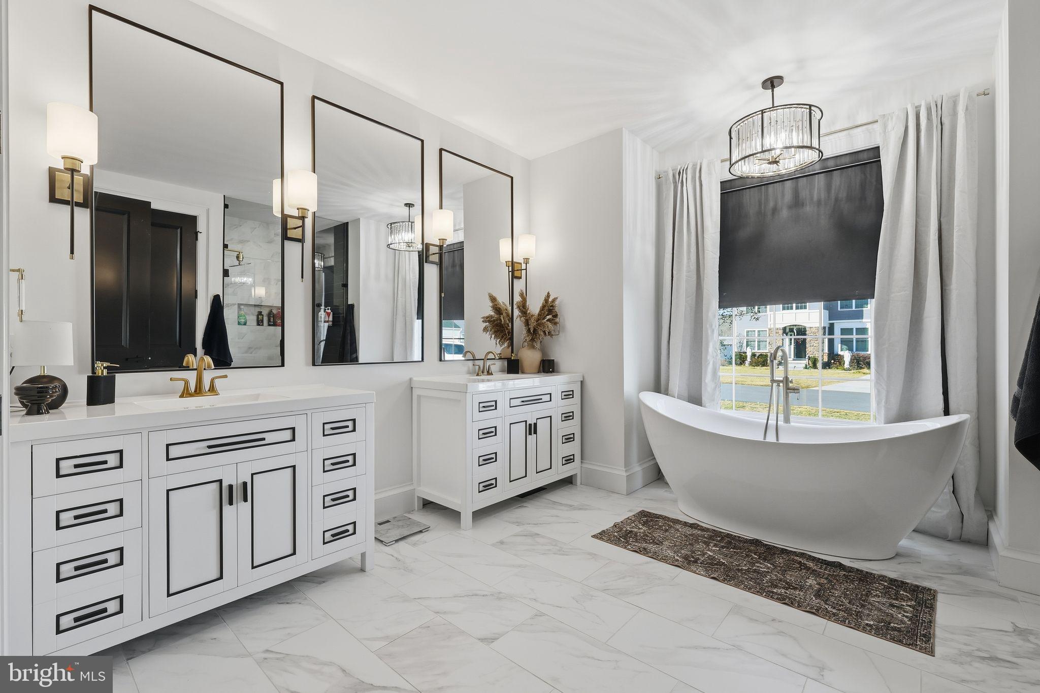 306 Shore Lane Milford, DE 19963 - Photo 20 of 38 a bathroom with a double vanity sink a mirror a bathtub and window
