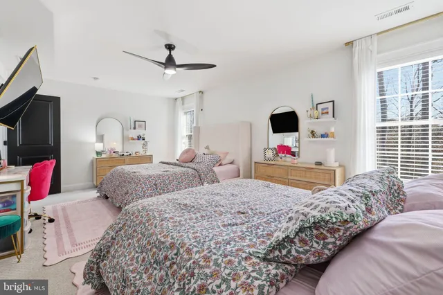a bedroom with a bed and flat screen tv