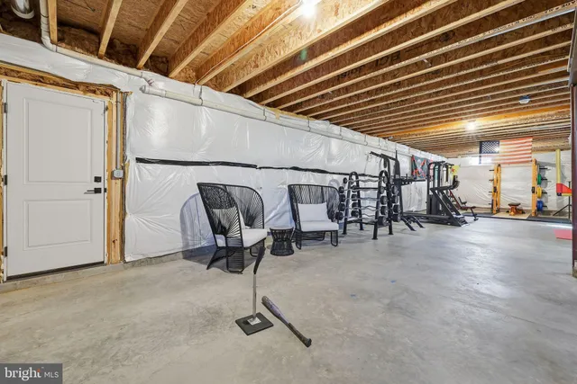 a view of a hallway with a table and chairs