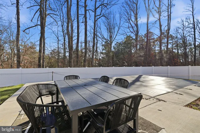 a view of a chairs and table on the roof deck